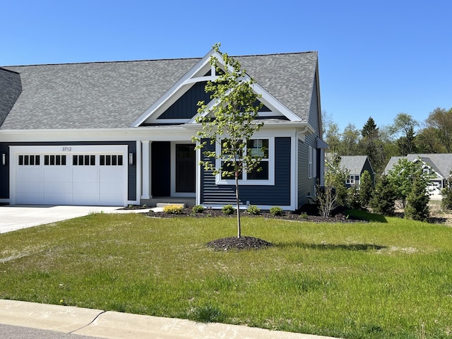 view of front of house with an attached garage, a shingled roof, a front lawn, concrete driveway, and board and batten siding