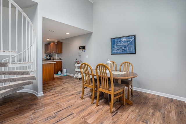 dining room featuring a high ceiling and light wood-type flooring