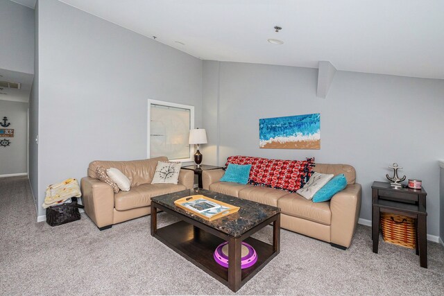 carpeted living room with vaulted ceiling