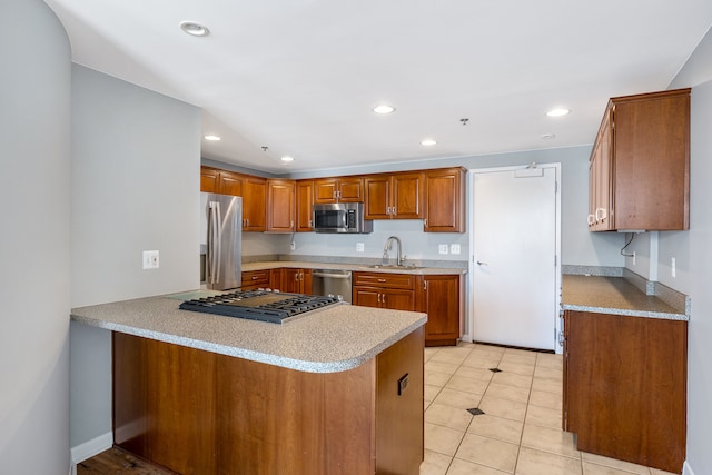 kitchen with kitchen peninsula, appliances with stainless steel finishes, light tile patterned floors, and sink