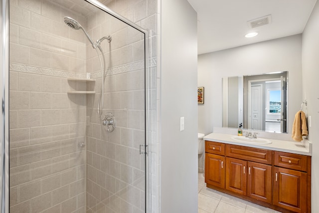 bathroom featuring tile patterned flooring, vanity, and walk in shower