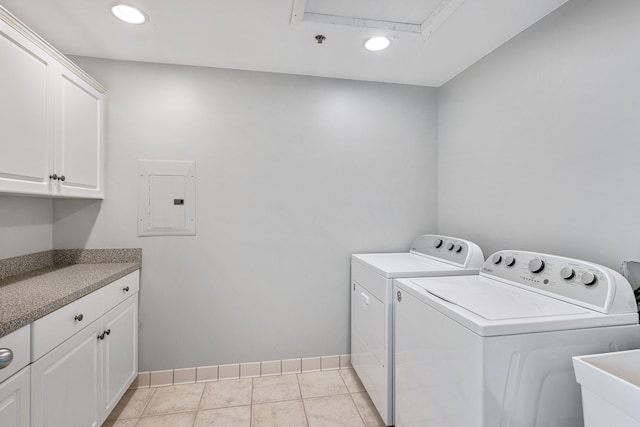 laundry room with cabinets, electric panel, sink, washer and dryer, and light tile patterned flooring