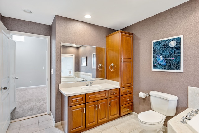 bathroom with a washtub, tile patterned flooring, vanity, and toilet