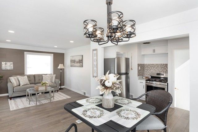 8410 Grandville Ave, Detroit, MI 48228 - dining space featuring a chandelier, wood finished floors, recessed lighting, and baseboards