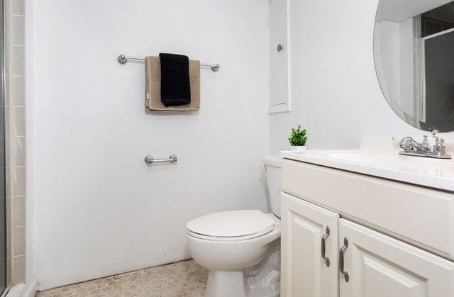 8410 Grandville Ave, Detroit, MI 48228 - full bath with vanity, toilet, and a tile shower