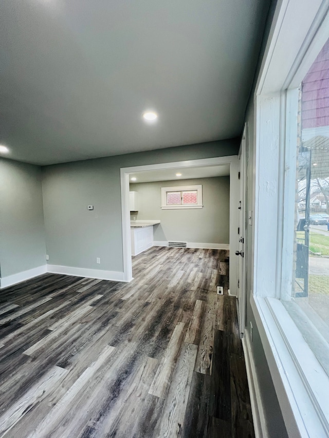 unfurnished living room featuring dark hardwood / wood-style flooring