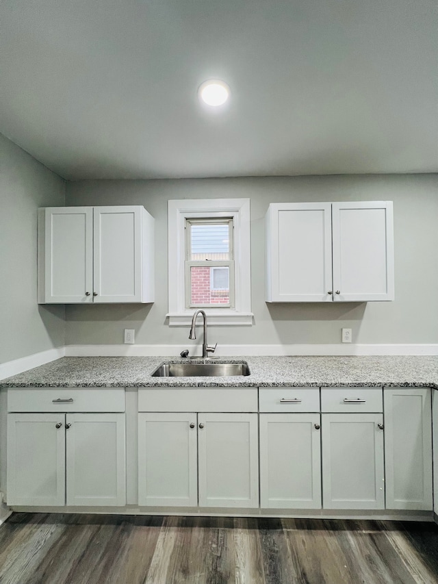 kitchen featuring white cabinets, dark hardwood / wood-style flooring, and sink