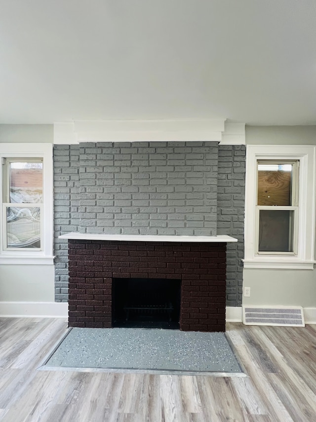 details with a fireplace and hardwood / wood-style flooring