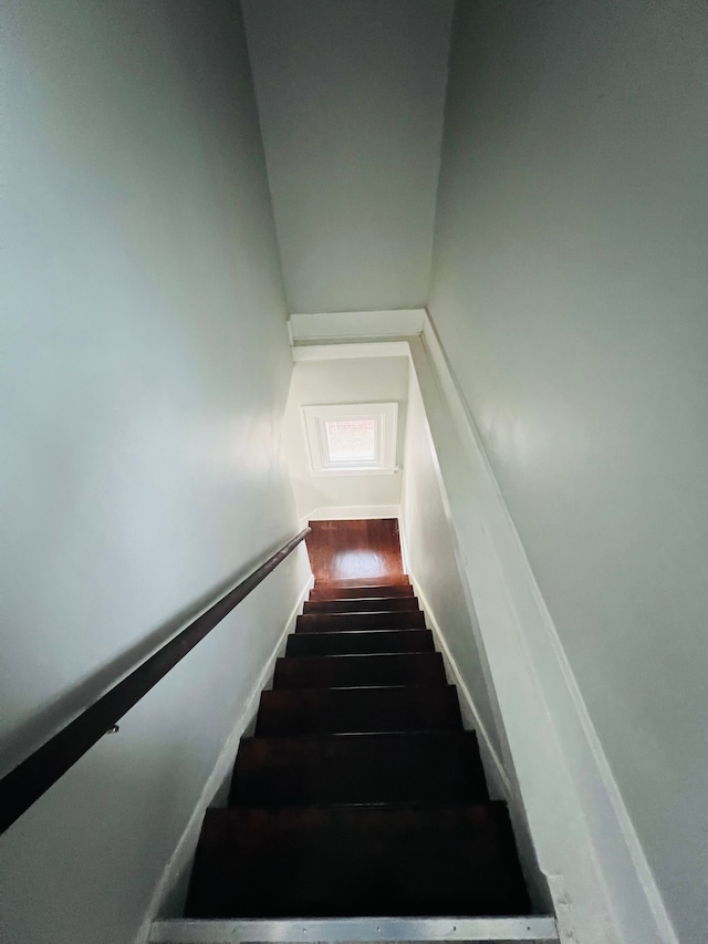 stairs with hardwood / wood-style floors