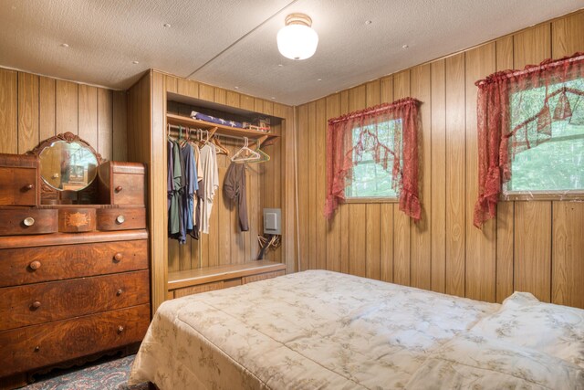 11451 Hemlock Ave, Lake, MI 48632 - bedroom featuring wooden walls and a closet