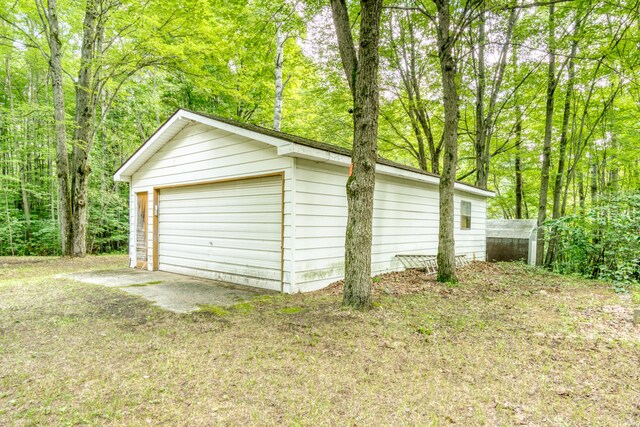 11451 Hemlock Ave, Lake, MI 48632 - detached garage featuring a wooded view