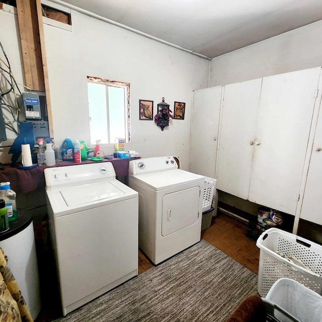 laundry room with wood-type flooring and washing machine and clothes dryer