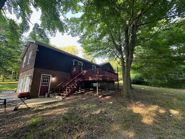 back of property with a garage and a deck