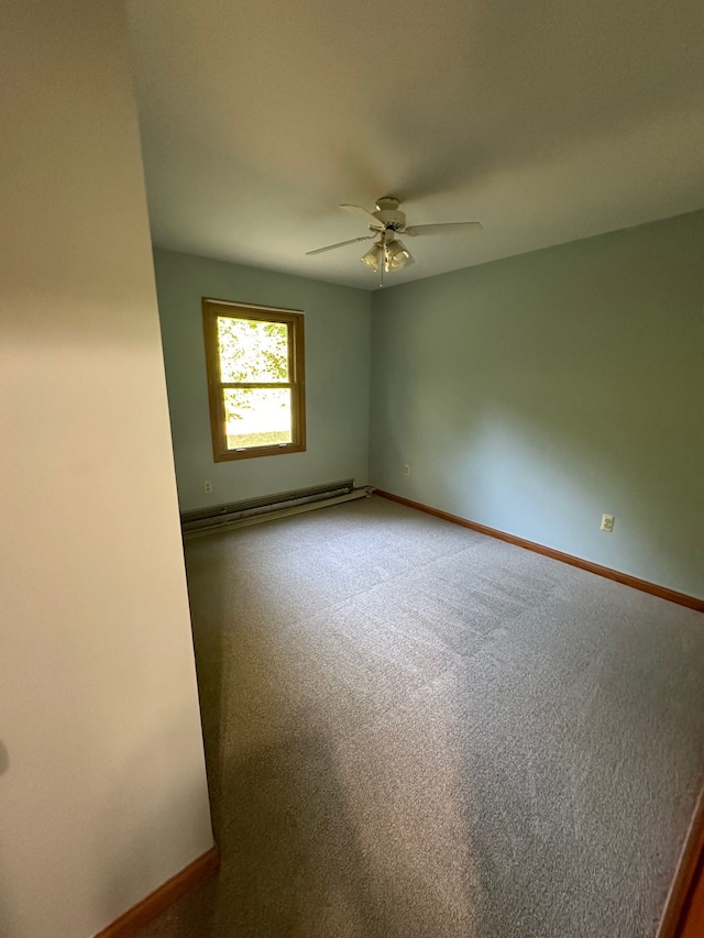 carpeted empty room featuring baseboard heating and ceiling fan