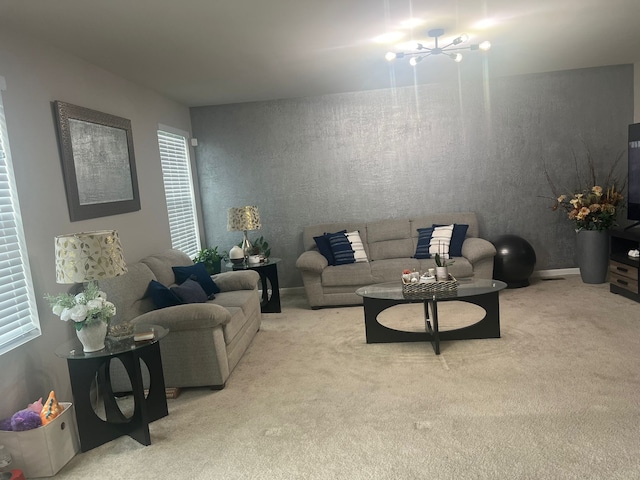 living room featuring carpet and an inviting chandelier