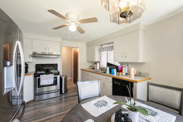 kitchen with light countertops, under cabinet range hood, stainless steel appliances, white cabinetry, and dark wood-type flooring