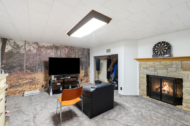 living room with a fireplace and carpet floors