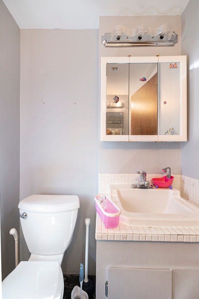 bathroom featuring vanity and toilet