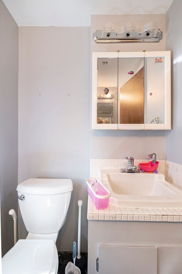 half bath with vanity and toilet