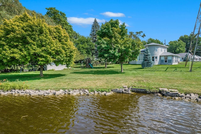 view of dock featuring a yard and a water view