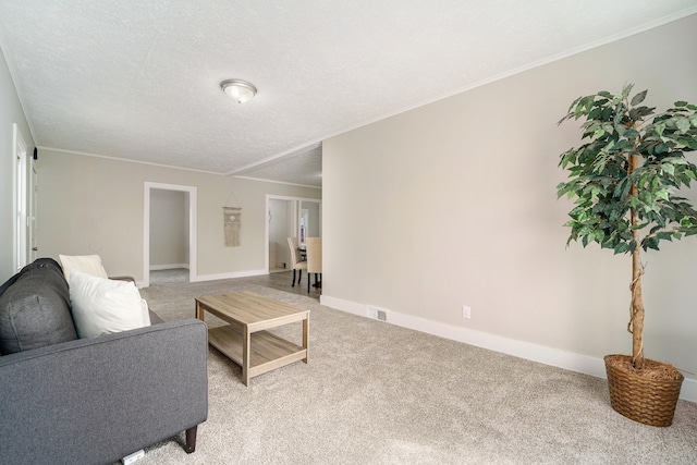 carpeted living room featuring a textured ceiling