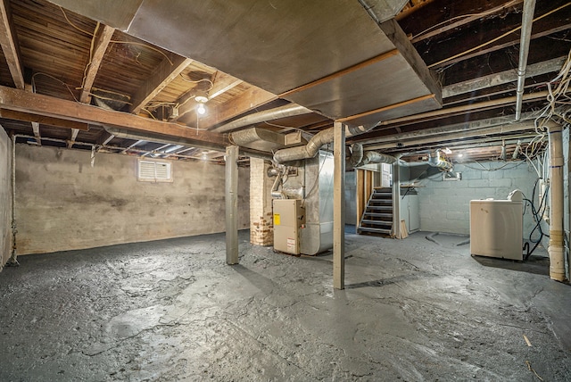 basement with separate washer and dryer and heating unit