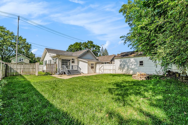 rear view of house featuring a lawn