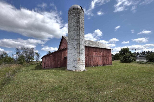 20682 Honor Hwy, Interlochen, MI 49643 - view of barn featuring a yard