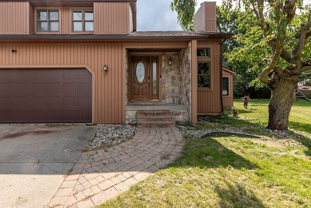 property entrance featuring a lawn and a garage