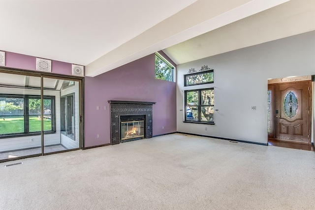 unfurnished living room with lofted ceiling with beams and light carpet