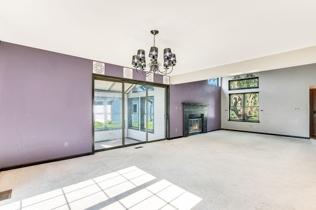 unfurnished living room with light colored carpet and a notable chandelier