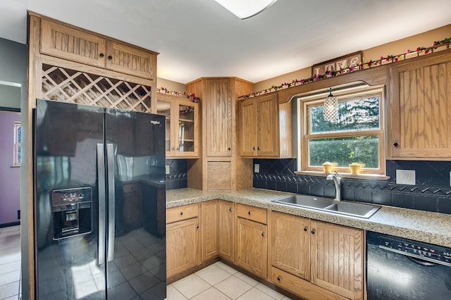 kitchen featuring light tile patterned floors, sink, backsplash, and black appliances