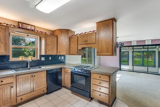 kitchen featuring black appliances, plenty of natural light, sink, and light carpet