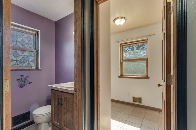 bathroom featuring tile patterned flooring, vanity, and toilet