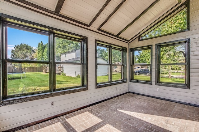 unfurnished sunroom featuring wood ceiling and lofted ceiling with beams