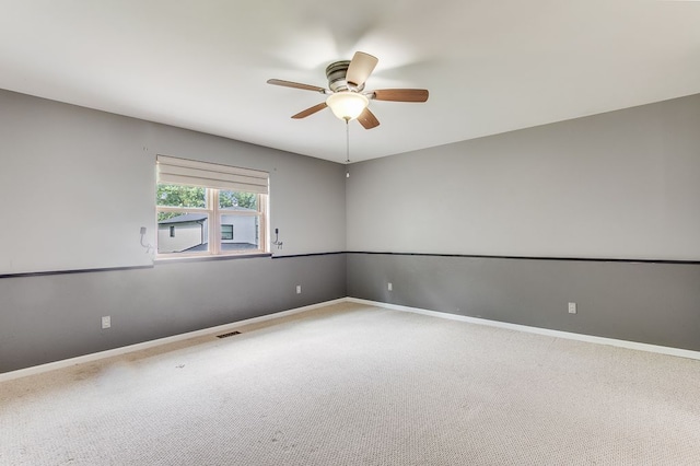 unfurnished room featuring ceiling fan and carpet