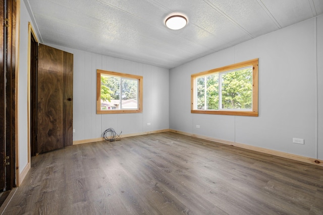 empty room featuring a textured ceiling and hardwood / wood-style flooring