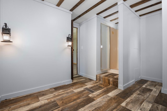 interior space featuring beamed ceiling and dark hardwood / wood-style floors