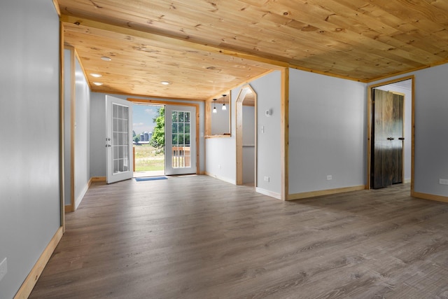 unfurnished living room with hardwood / wood-style floors, wooden ceiling, and french doors