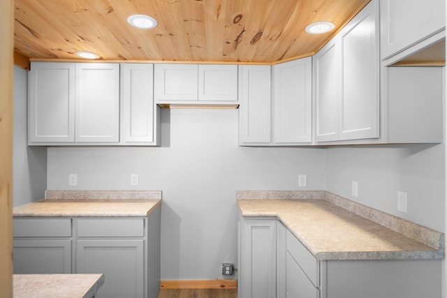 kitchen with hardwood / wood-style flooring and wooden ceiling