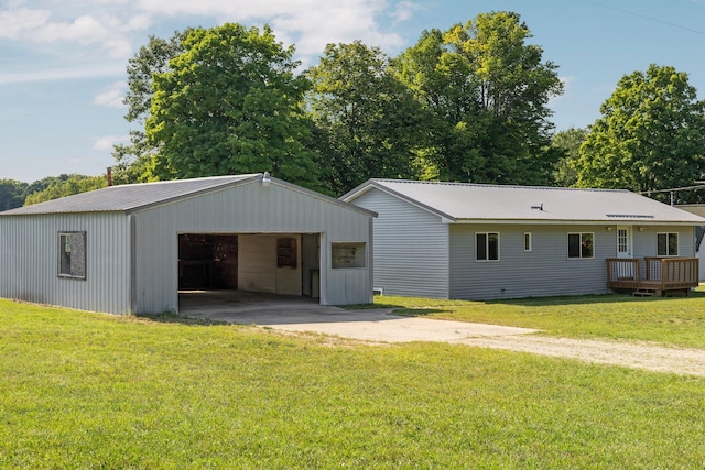 back of property featuring an outbuilding and a yard