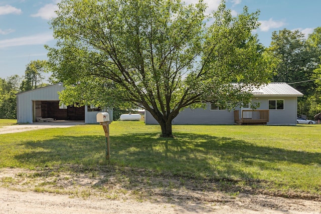 view of yard featuring a garage and an outbuilding