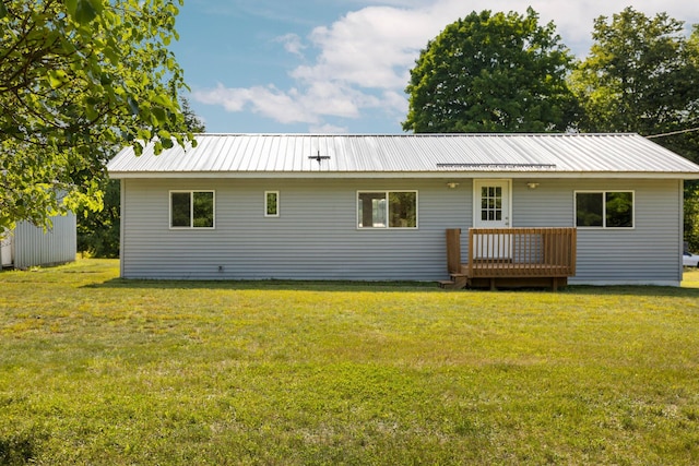 rear view of property with a yard