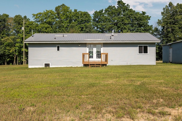 back of house featuring a lawn and french doors