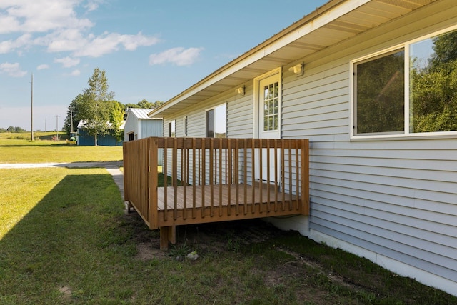 wooden terrace featuring a lawn