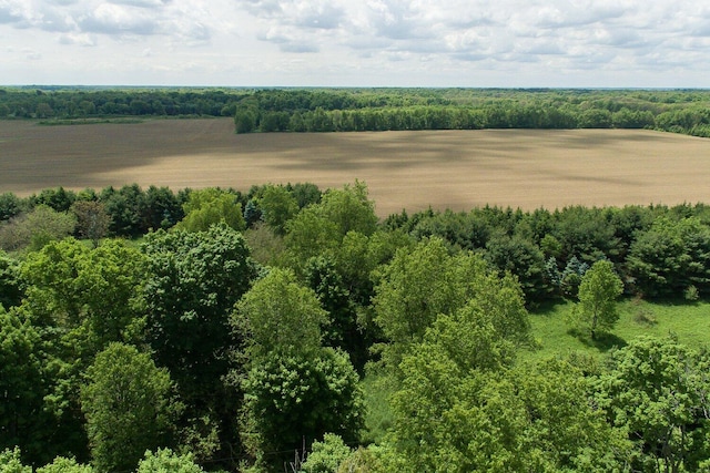 drone / aerial view featuring a rural view and a forest view