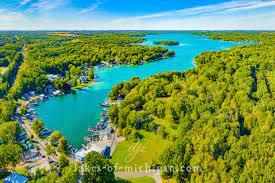 aerial view with a water view and a wooded view