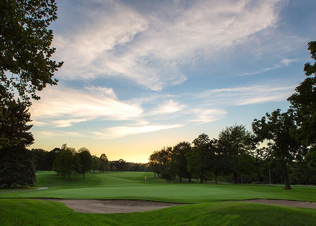 surrounding community with a lawn and golf course view