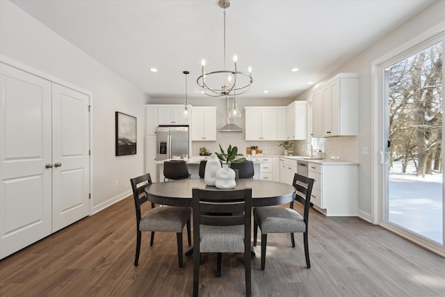 dining space featuring recessed lighting, baseboards, and wood finished floors