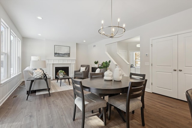 dining area with baseboards, a fireplace, dark wood finished floors, and recessed lighting